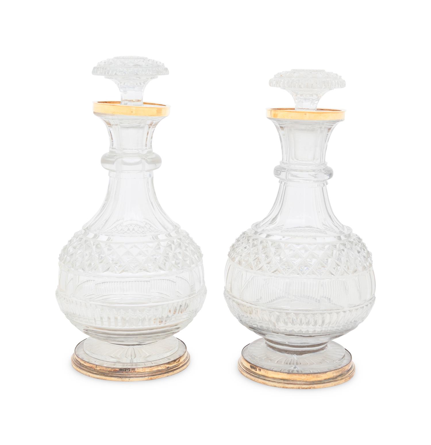 A Near Pair of George III Silver-Gilt Mounted Cut Glass Decanters