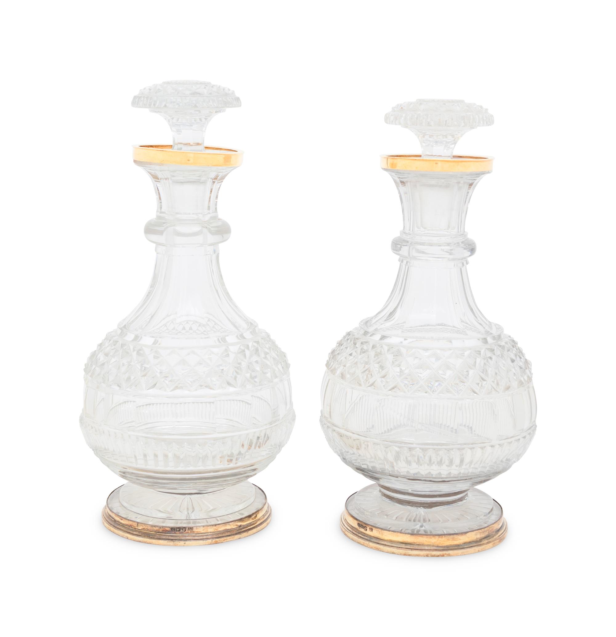 A Near Pair of George III Silver-Gilt Mounted Cut Glass Decanters