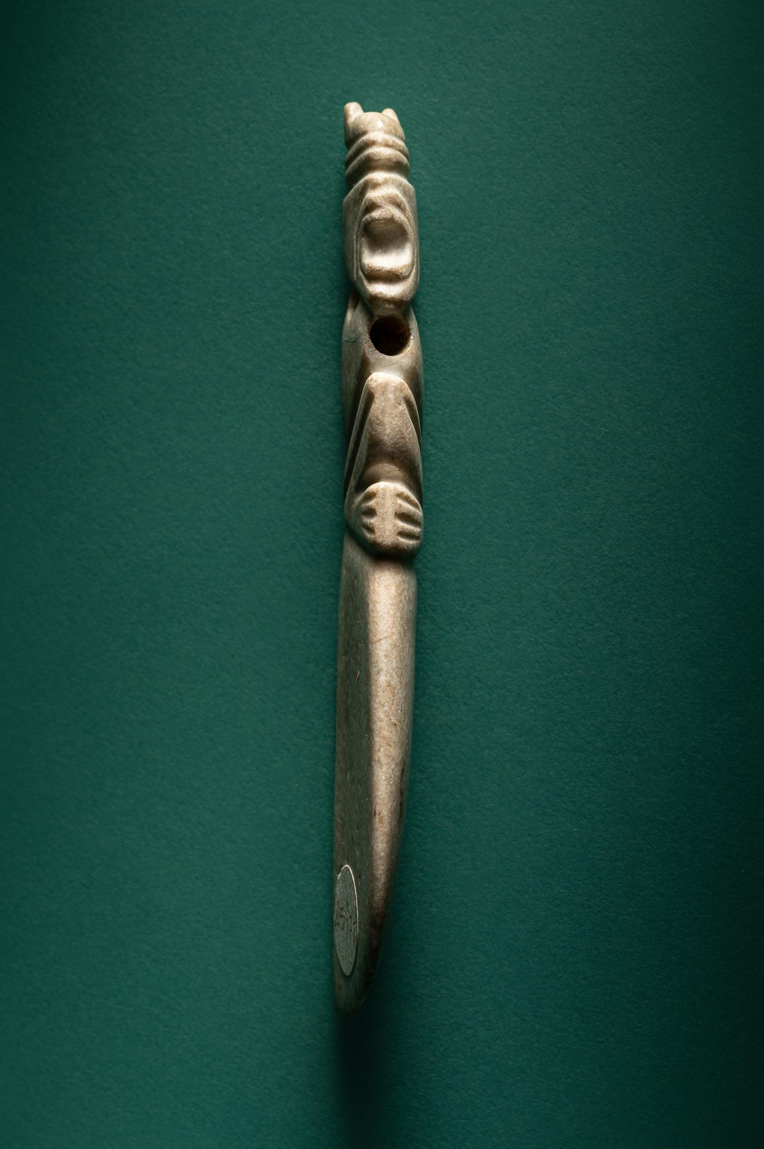 A Costa Rican White Jade Axe Pendant of a Crouching Monkey