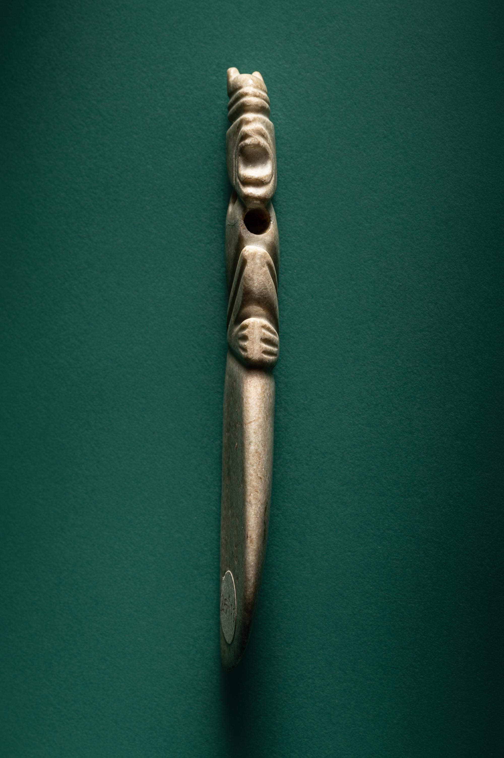 A Costa Rican White Jade Axe Pendant of a Crouching Monkey