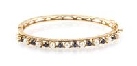 A 14 Karat Yellow Gold, Cultured Pearl and Sapphire Hinged Bangle Bracelet, 7.60 dwts.