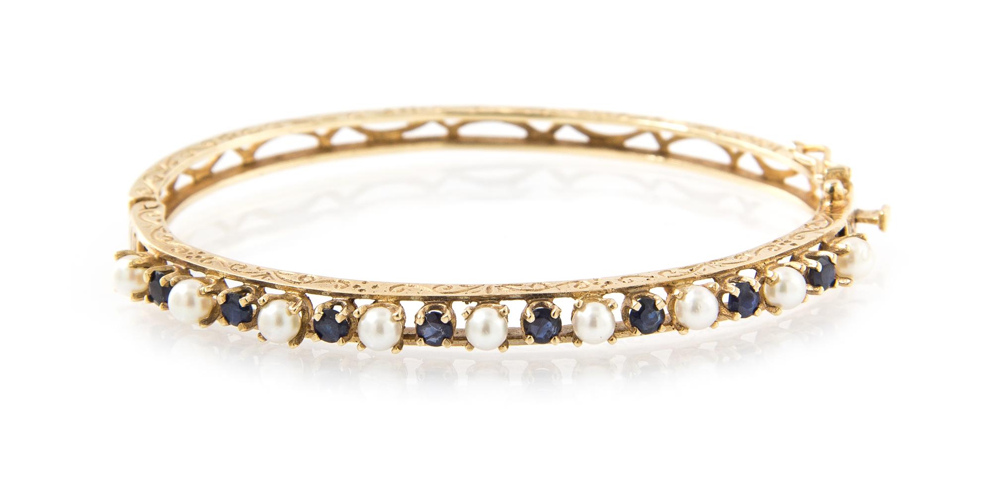 A 14 Karat Yellow Gold, Cultured Pearl and Sapphire Hinged Bangle Bracelet, 7.60 dwts.