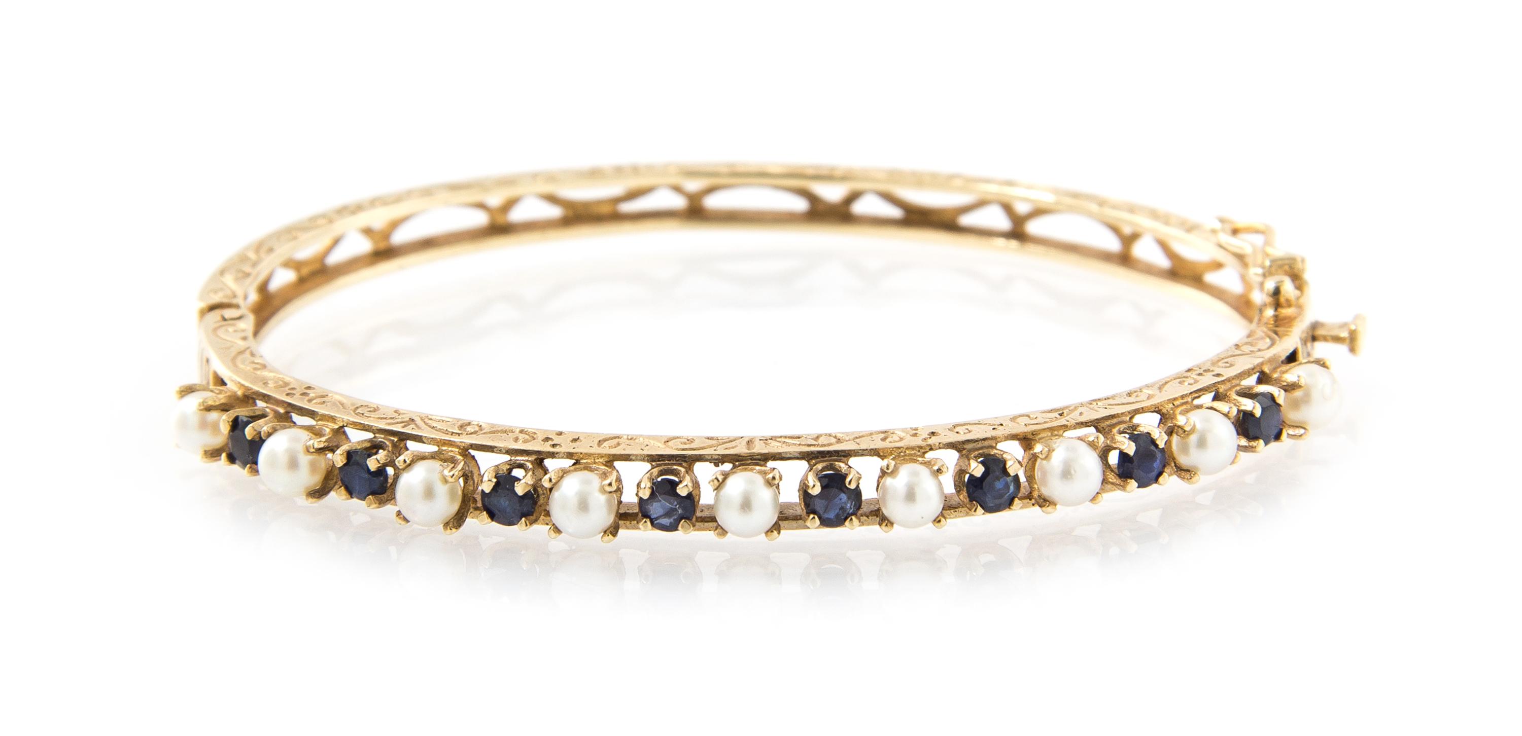A 14 Karat Yellow Gold, Cultured Pearl and Sapphire Hinged Bangle Bracelet, 7.60 dwts.