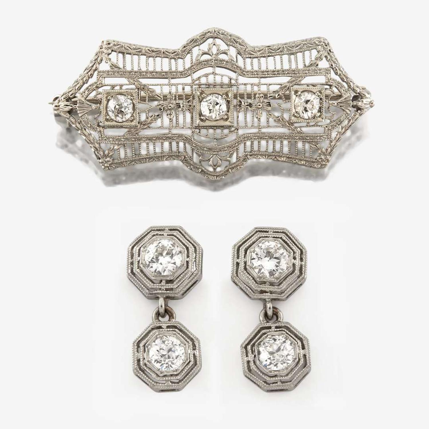 An Art Deco white gold and diamond brooch, together with platinum and diamond earrings