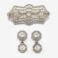 An Art Deco white gold and diamond brooch, together with platinum and diamond earrings