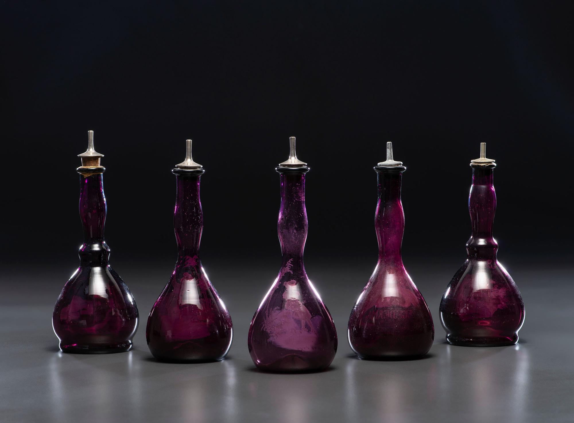 Five 'Mary Gregory' Amethyst Glass Barber Bottles