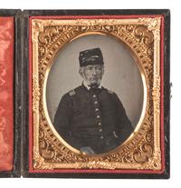 [CIVIL WAR] Sixth plate ambrotype of an aged captain sporting a tarred kepi cover.