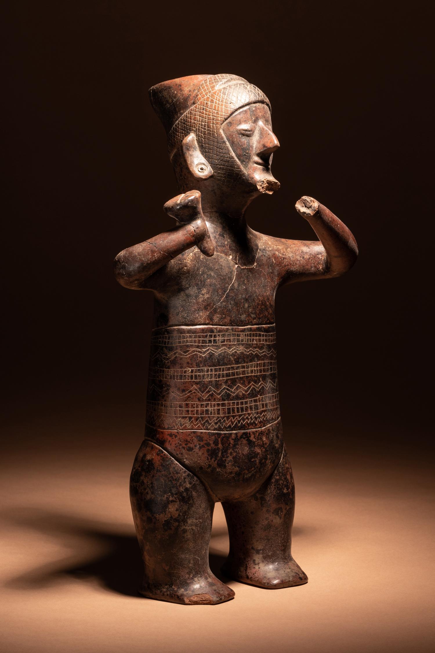 A Colima Terracotta Standing Male Figure with Incised Decoration