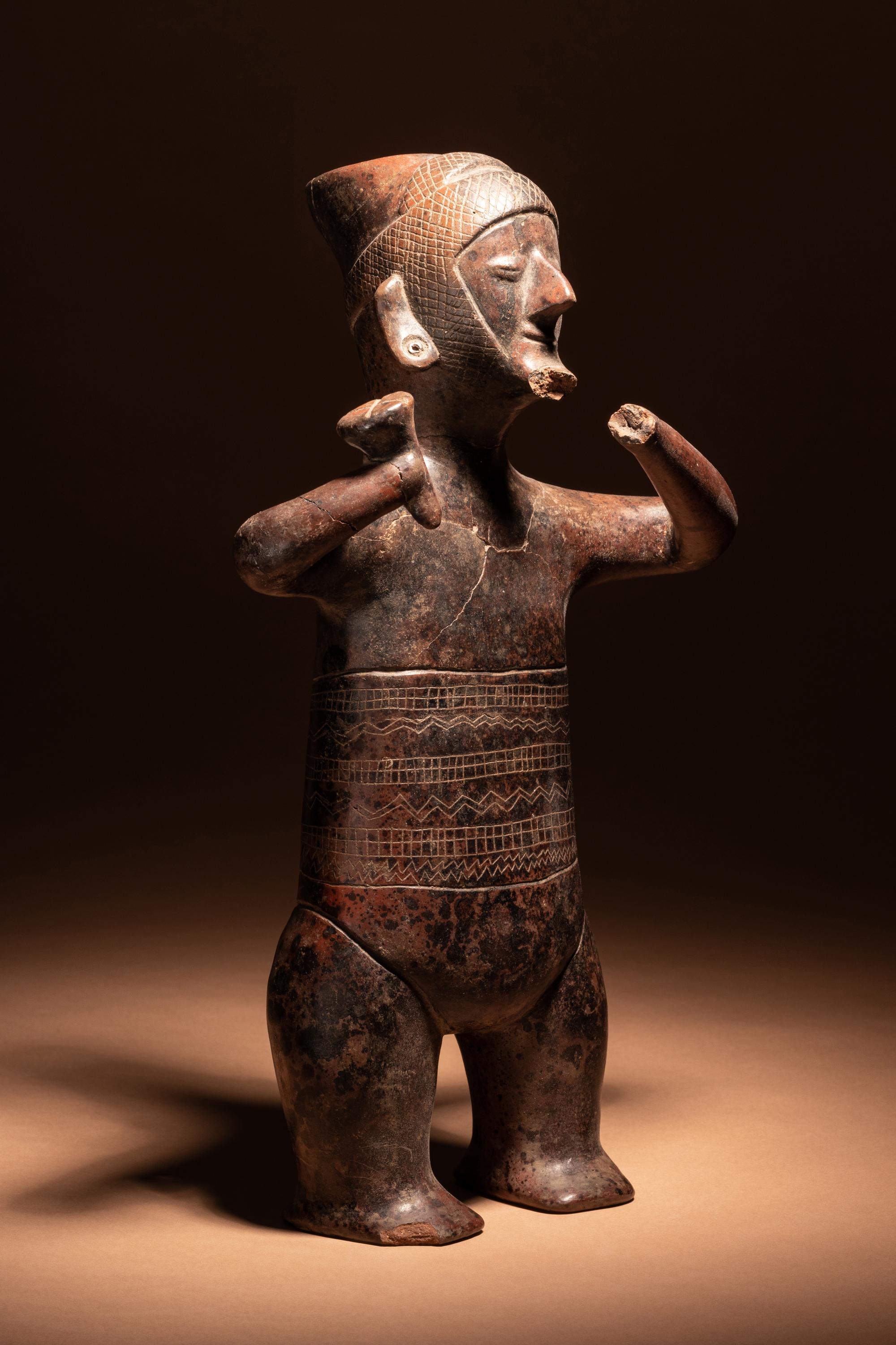 A Colima Terracotta Standing Male Figure with Incised Decoration
