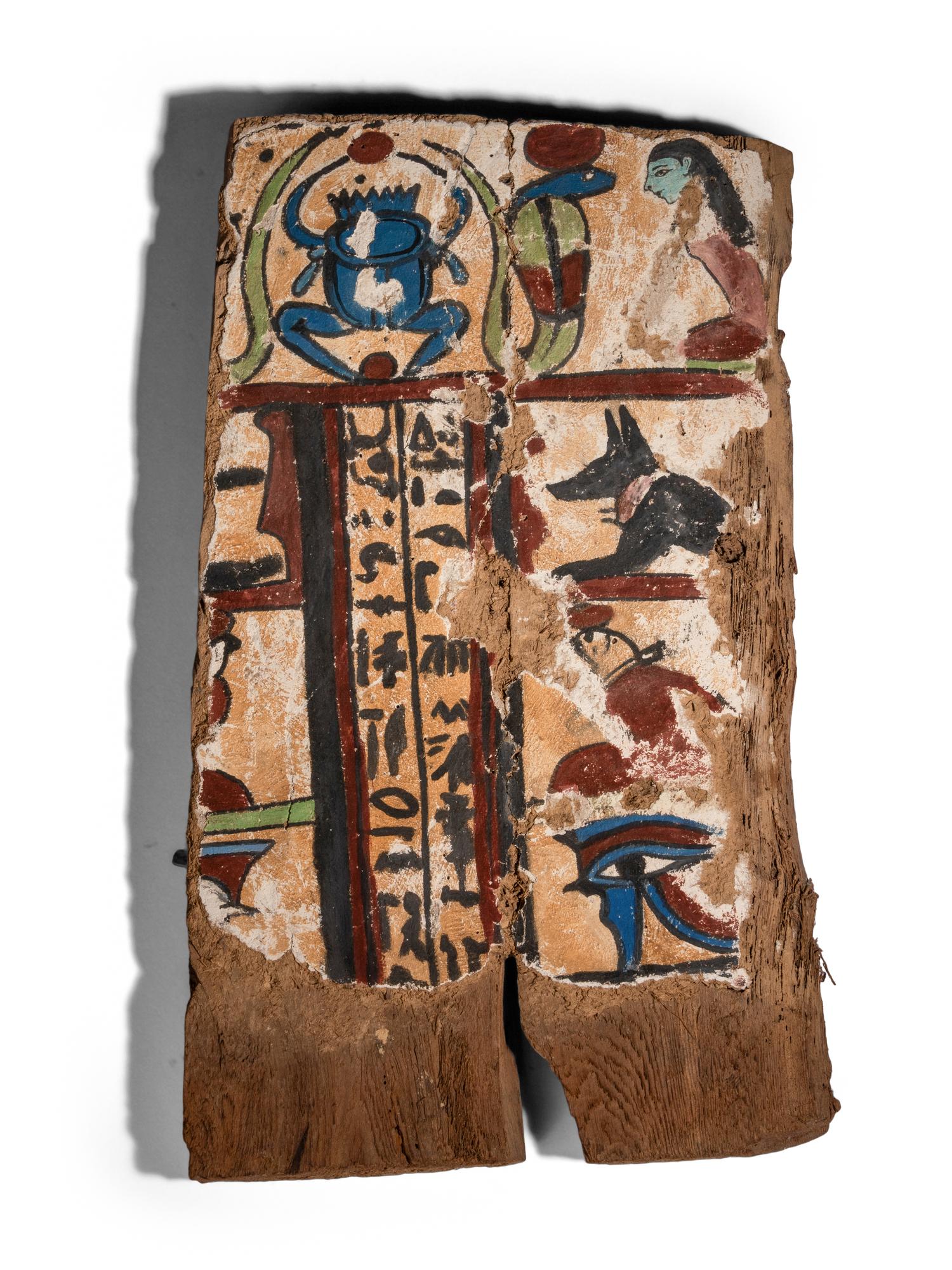 An Egyptian Painted Wood Sarcophagus Fragment with a Scarab