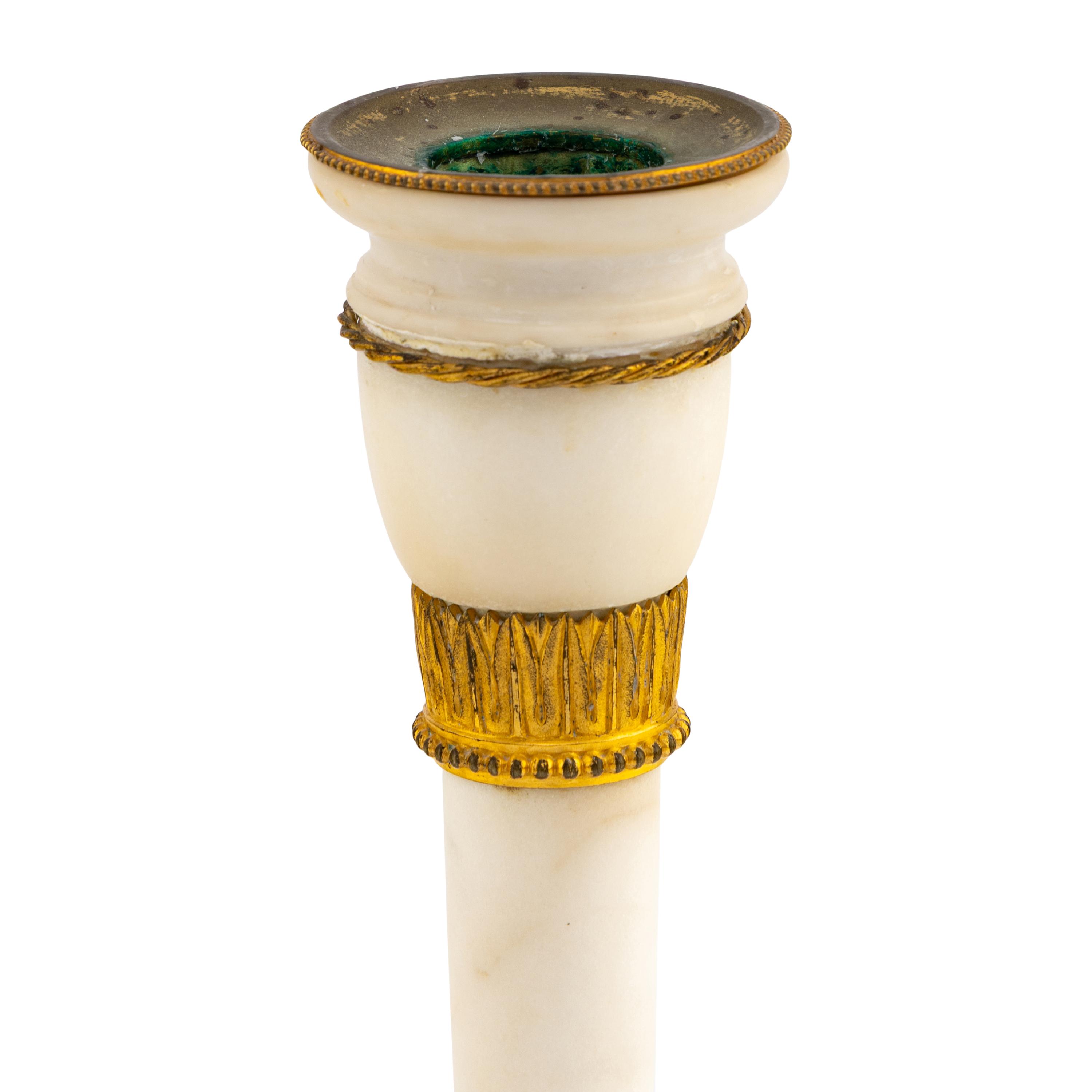 A Pair of Directoire Gilt Bronze and White Marble Candlesticks