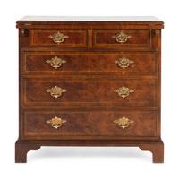 A Baker George III Style Walnut and Mahogany Bachelor's Chest