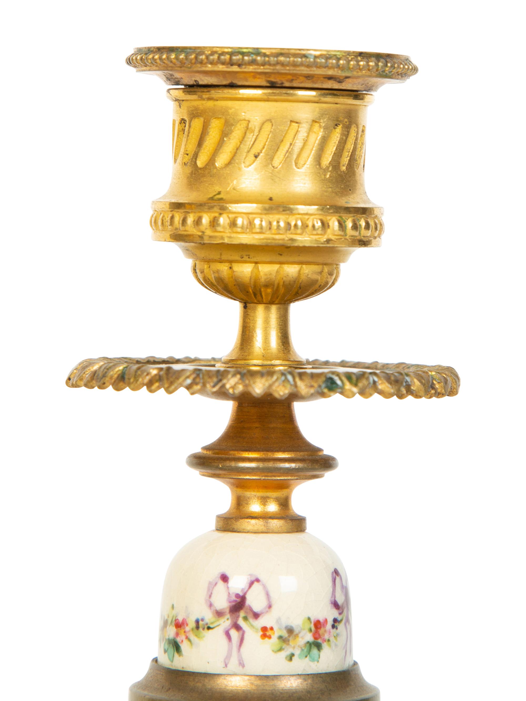 A Pair of French Gilt Bronze and Painted Porcelain Candlesticks