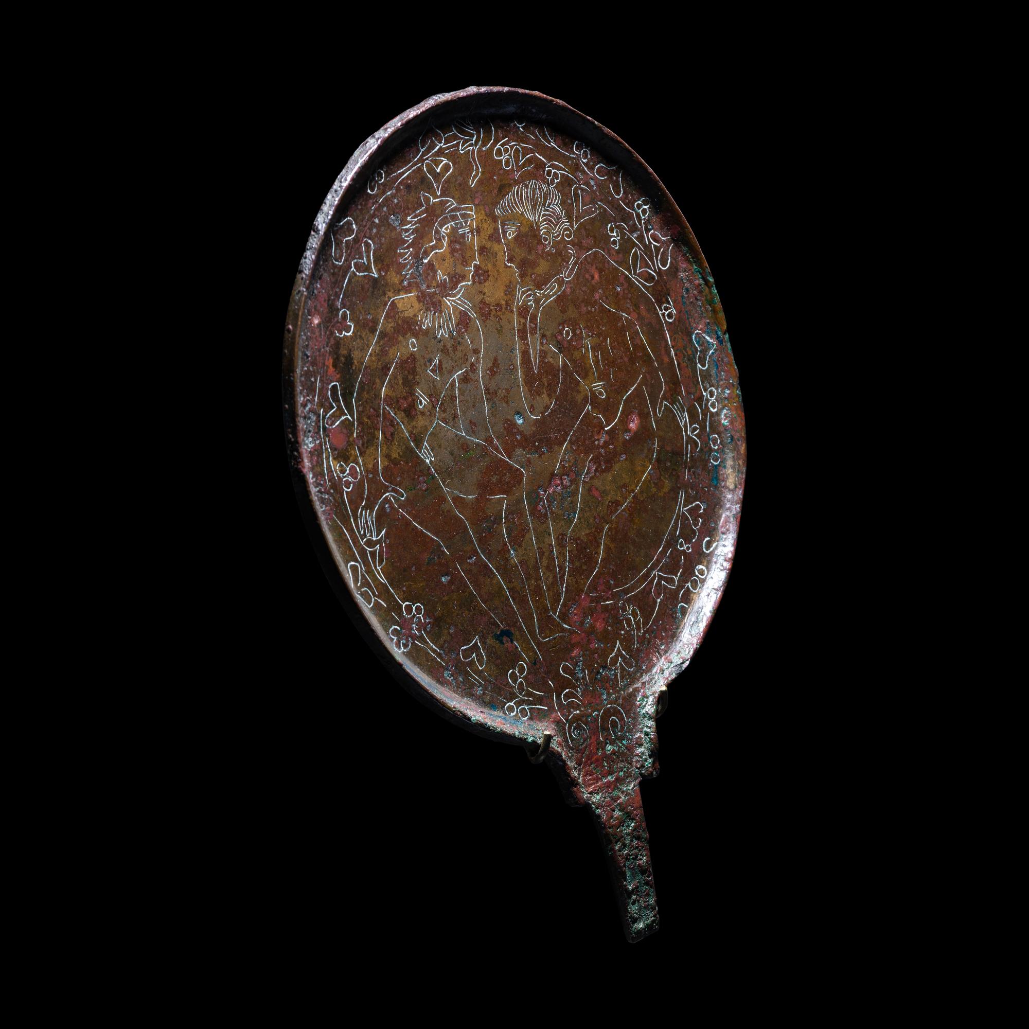 An Etruscan Bronze Mirror with Incised Scene of Hercules and Apollo