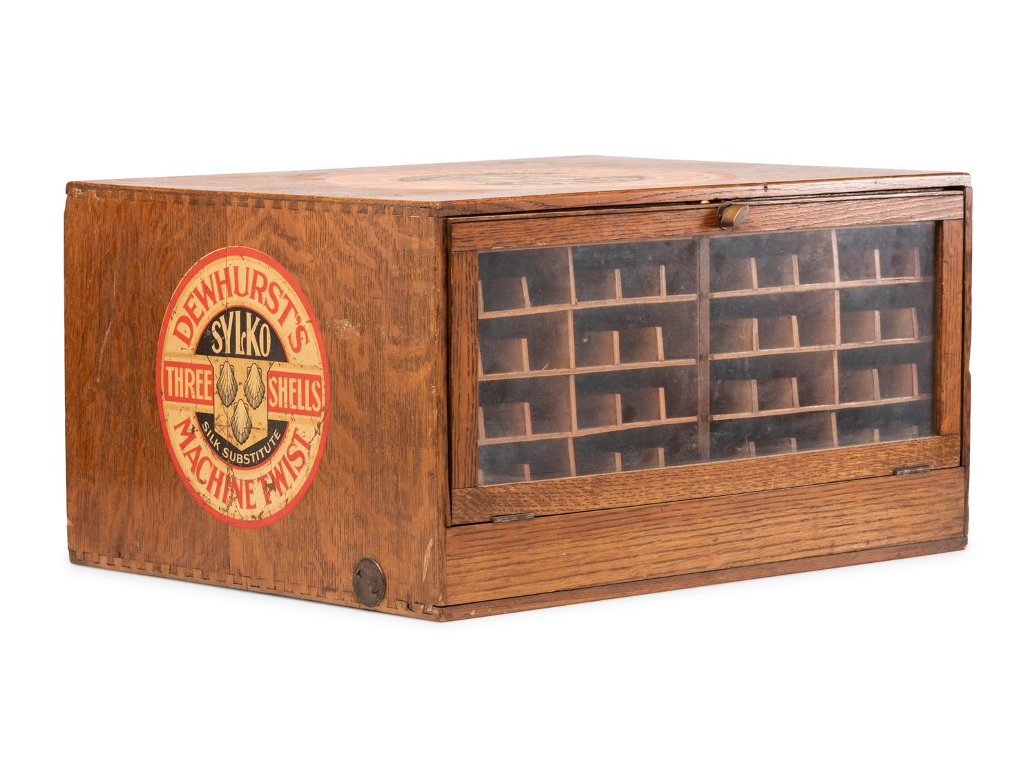A Dewhurst's "Sylko" Stenciled Oak Spool Cabinet