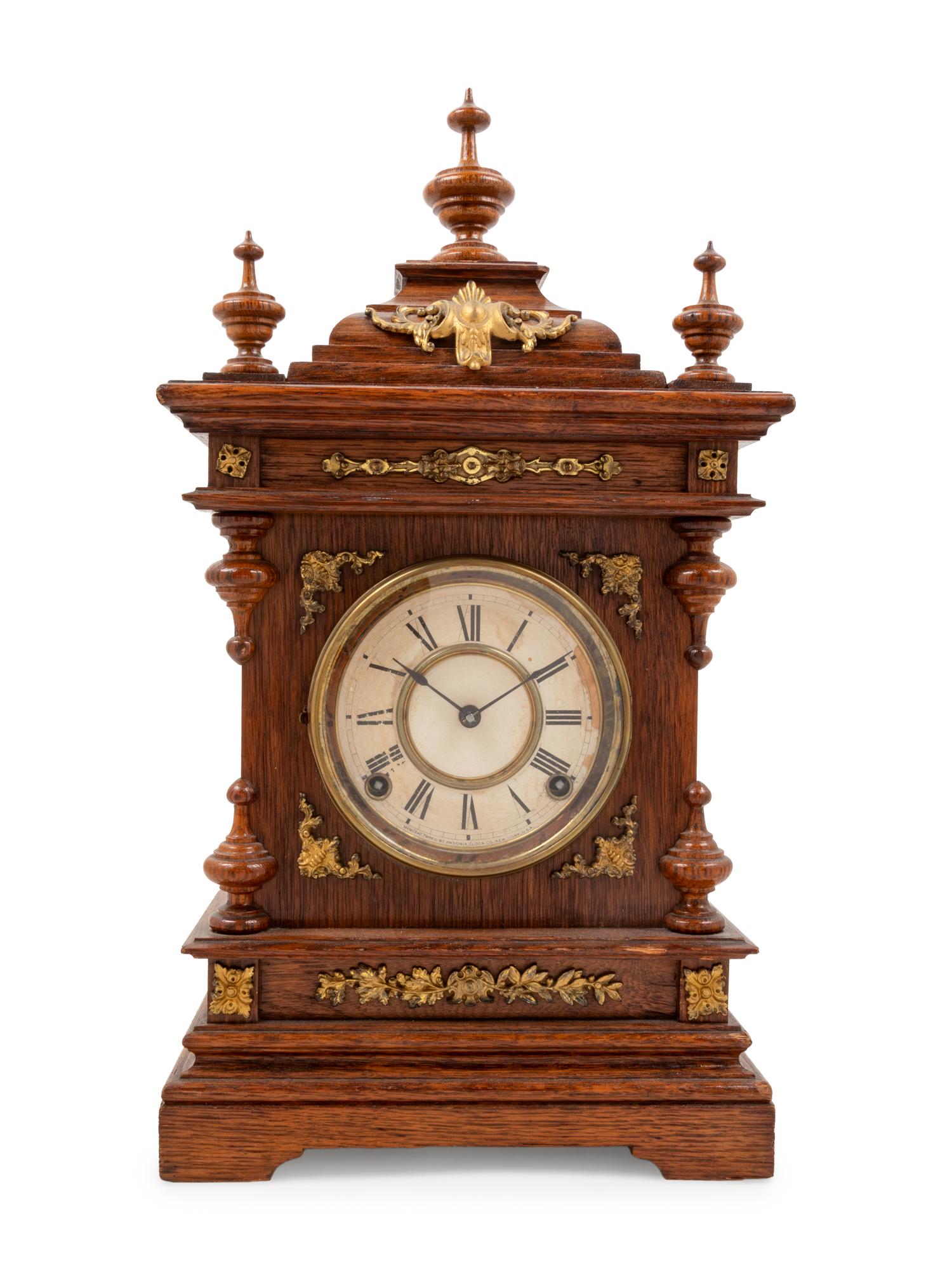 An Ansonia Cabinet A Brass Mounted Oak Shelf Clock