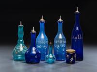 Seven Enameled Glass Barber Items