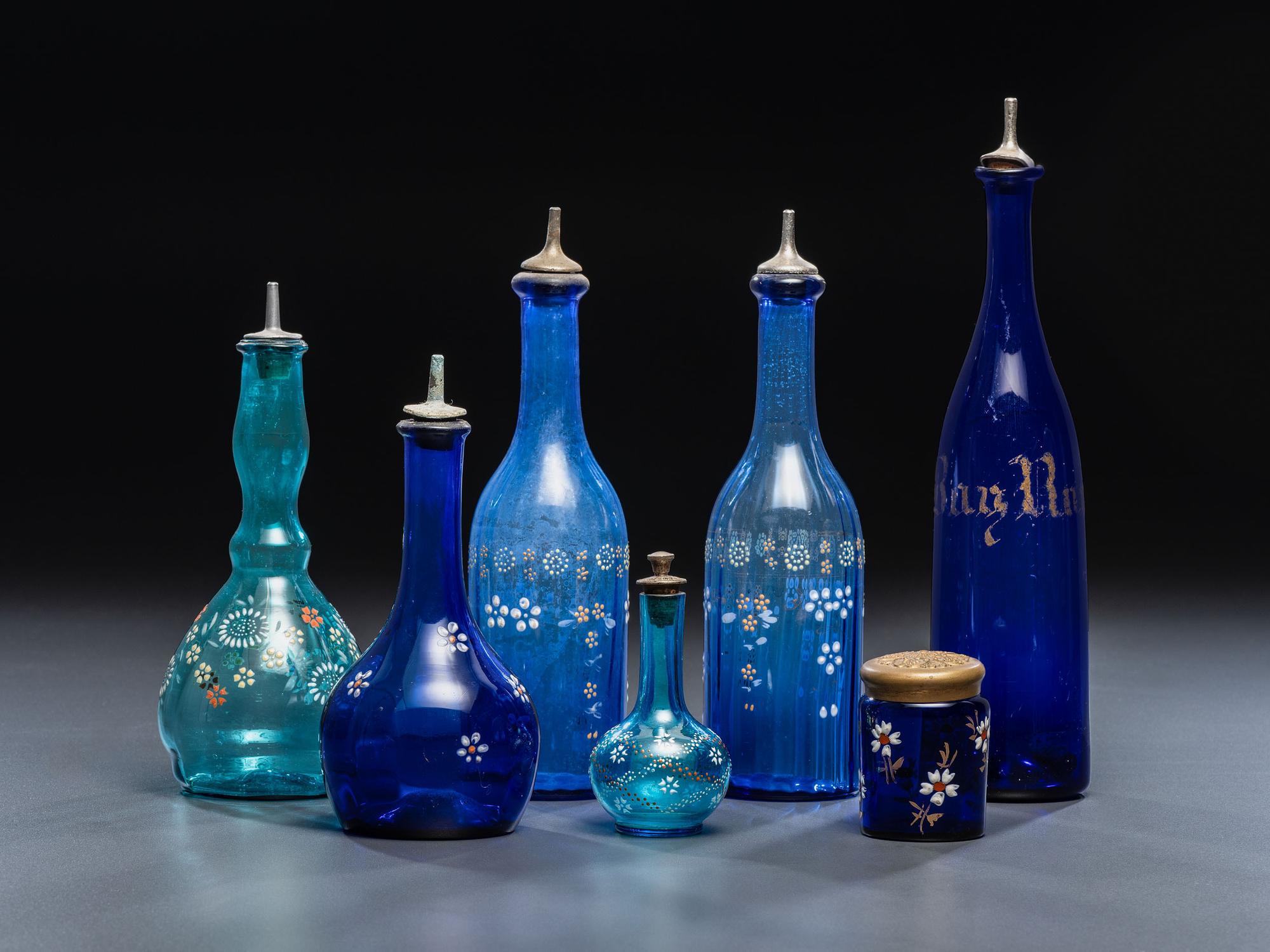 Seven Enameled Glass Barber Items