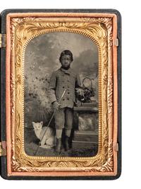 [AFRICAN AMERICANA - EARLY PHOTOGRAPHY]. Charming tintype portrait of young African American male subject and studio prop of a cat.