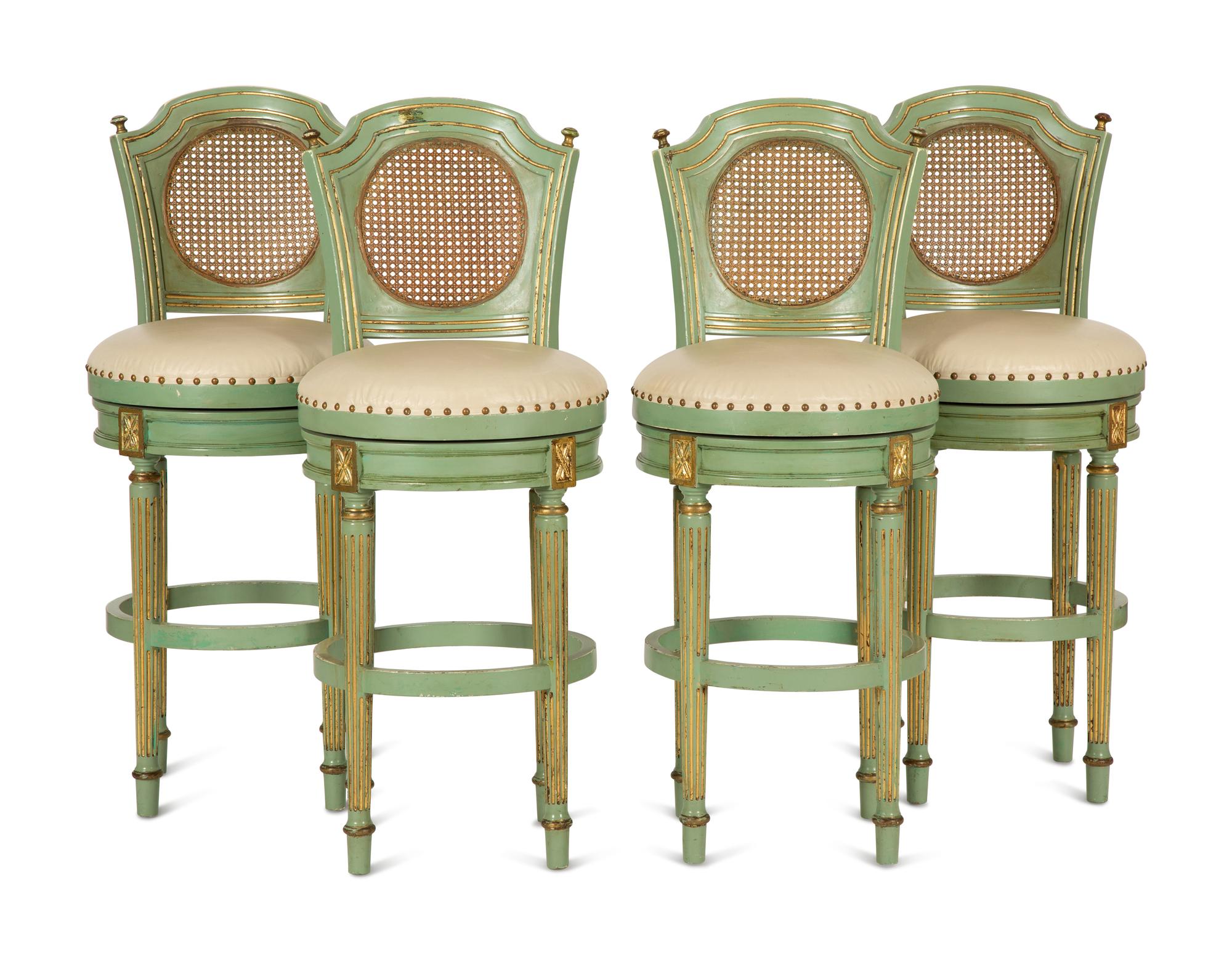 Four Louis XVI Style Painted, Parcel Gilt and Cane Back Bar Stools