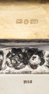 A Victorian Silver Vinaigrette, Robert Thornton, Birmingham, 1870, having a shaped rectangular case, the lid centered by an envgaved mo