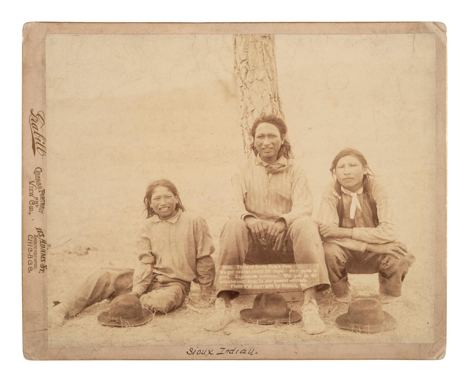 [NATIVE AMERICANS]. Photograph of three young Sioux men. Chicago: Grabill, 1890.