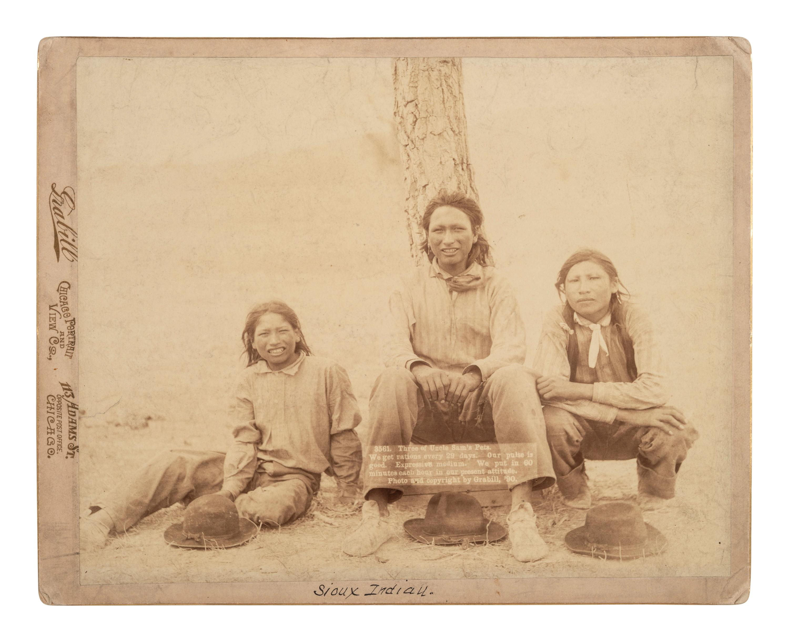 [NATIVE AMERICANS]. Photograph of three young Sioux men. Chicago: Grabill, 1890.