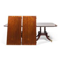 A Regency Style Mahogany and Rosewood Double Pedestal Extension Dining Table