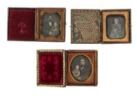 [EARLY PHOTOGRAPHY - PORTRAITURE]. A pair of daguerreotypes featuring a father holding his daughter on his lap, with hand painted and other cases, including: