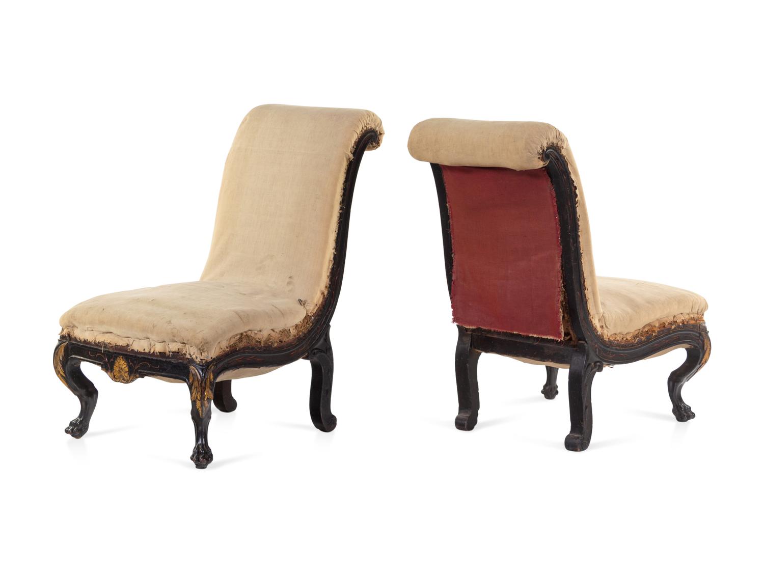 A Pair of Anglo-Colonial Carved and Parcel Gilt Slipper Chairs