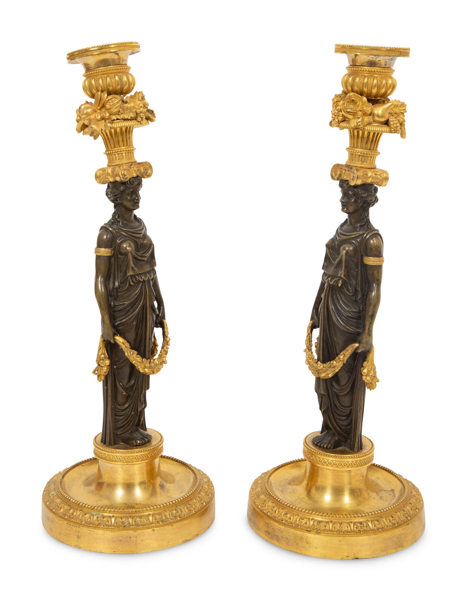 A Pair of French Gilt and Patinated Bronze Figural Candlesticks