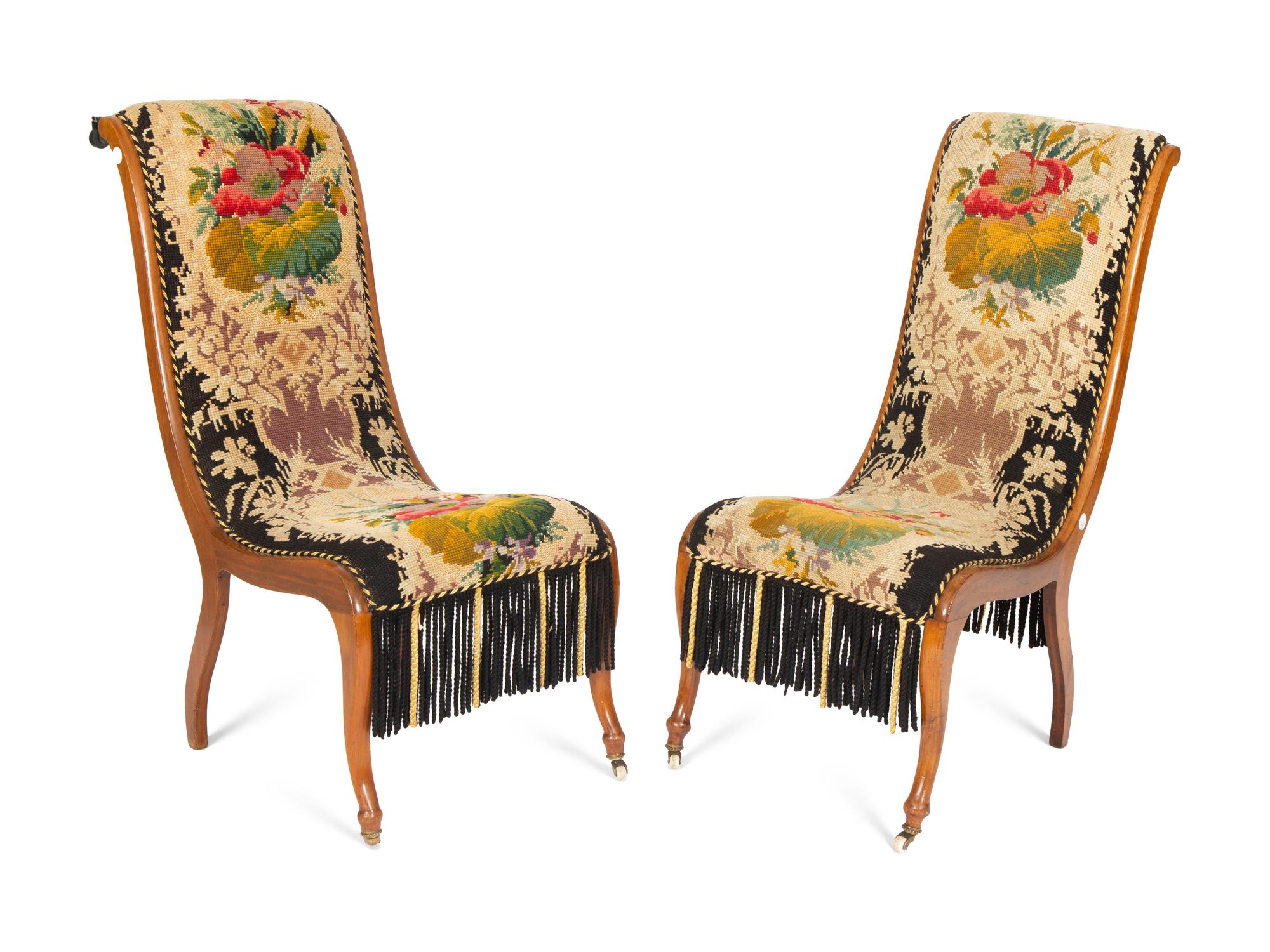 A Pair of Danish Walnut Slipper Chairs with Needlepoint Upholstery