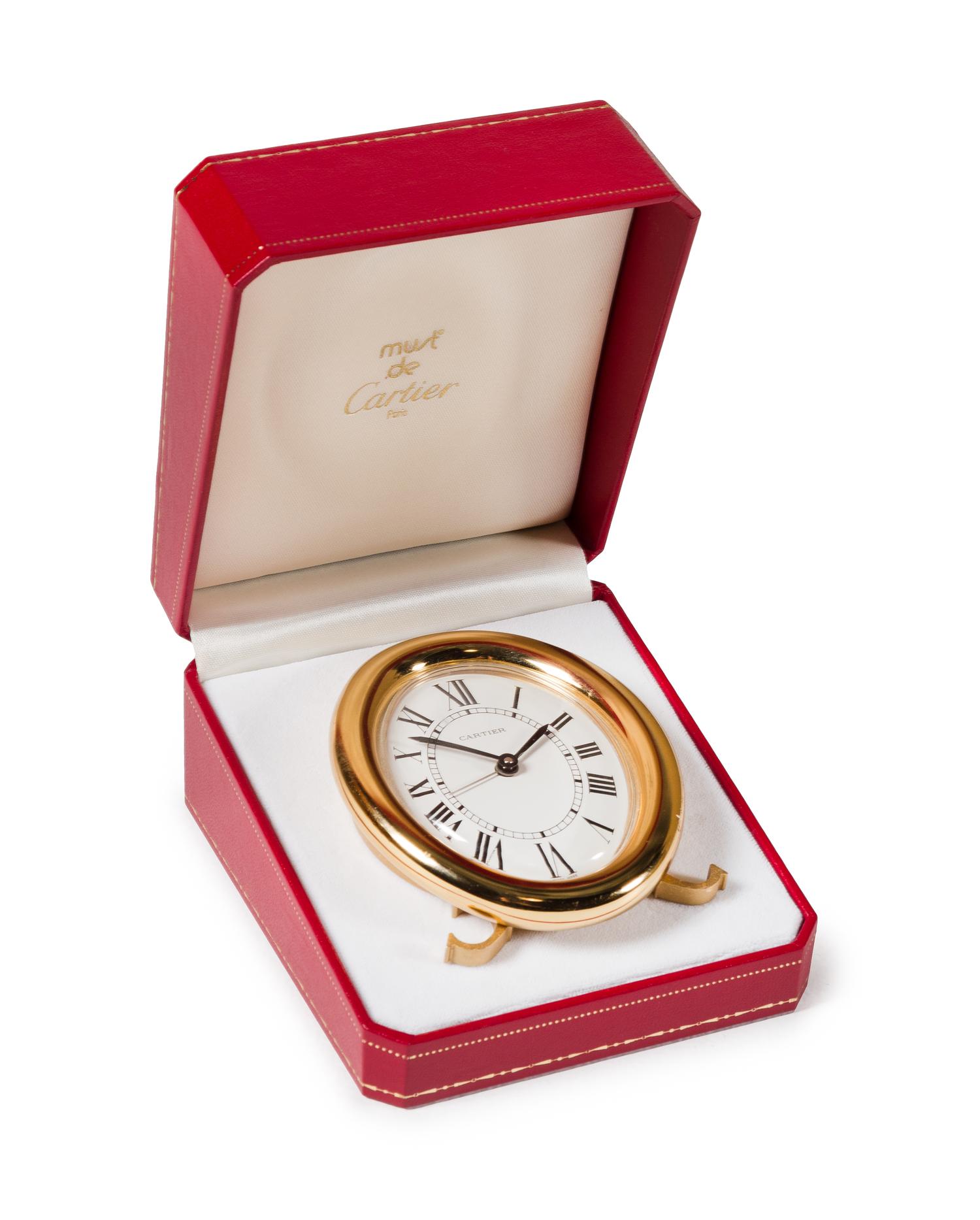 A Cartier Brass Travel Alarm Clock Height 3 1/2 inches. — 20TH CENTURY