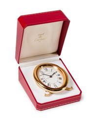 A Cartier Brass Travel Alarm Clock Height 3 1/2 inches. — 20TH CENTURY