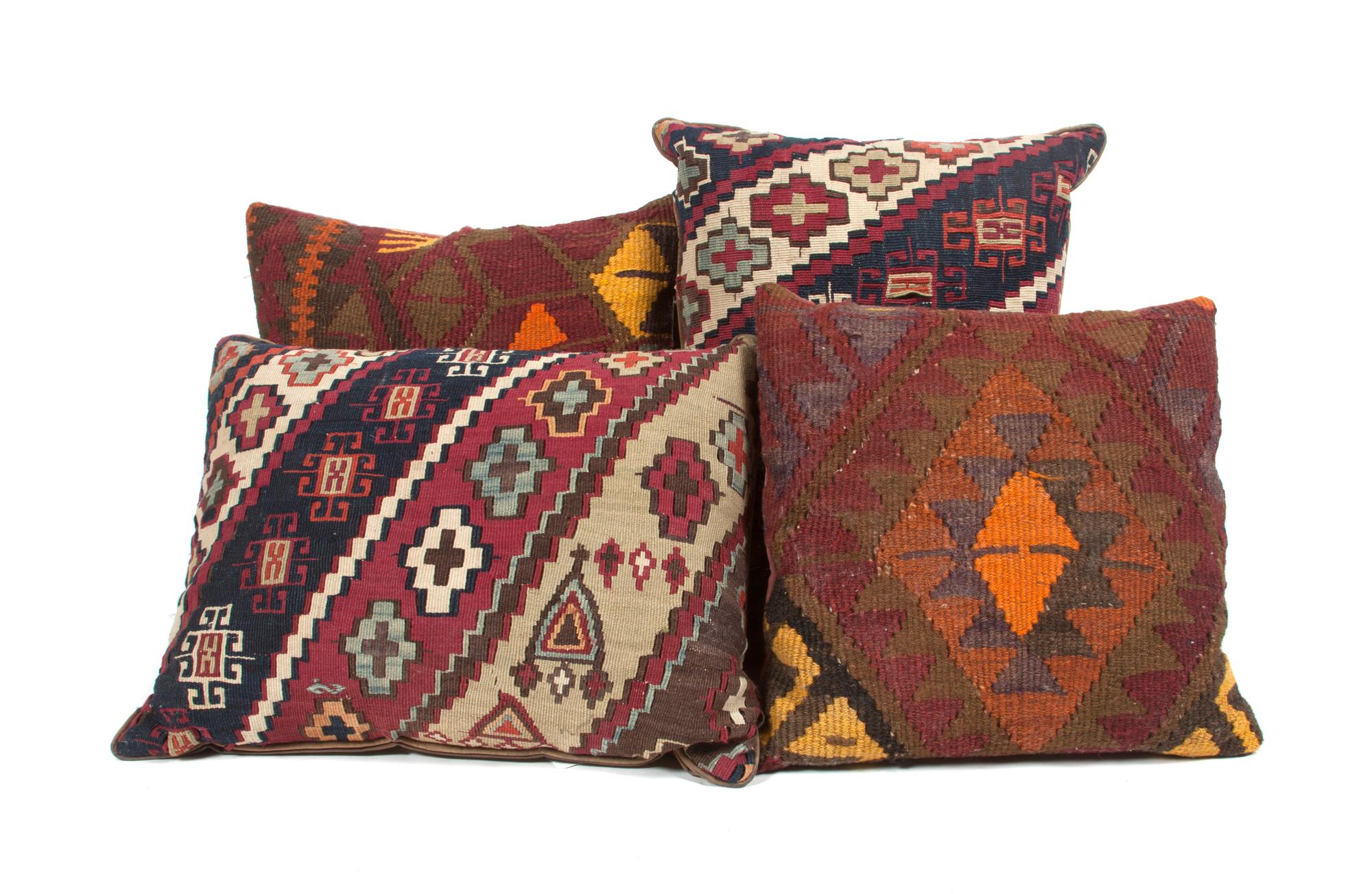 A Collection of Four Kilim Upholstered Pillows Height of largest 16 inches.