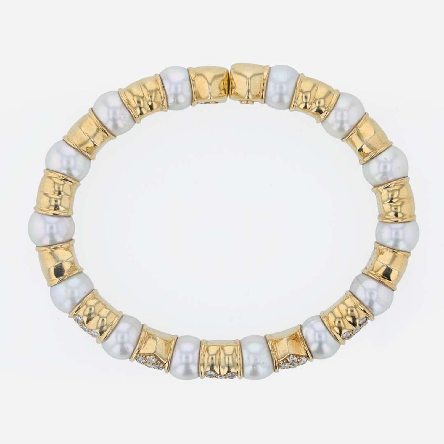 An 18K yellow gold, cultured pearl, and diamond bangle Italy