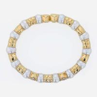 An 18K yellow gold, cultured pearl, and diamond bangle Italy
