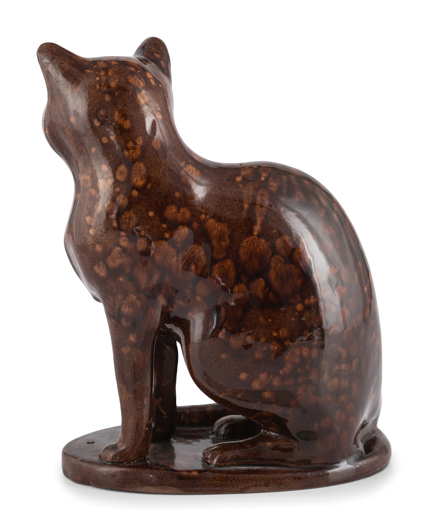 A Seated Cat Figure In Rockingham Glaze