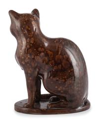 A Seated Cat Figure In Rockingham Glaze