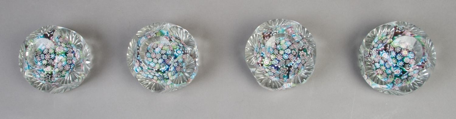 A Collection of Four Faceted Caned Paperweights, Diameter 3 inches.
