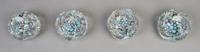 A Collection of Four Faceted Caned Paperweights, Diameter 3 inches.