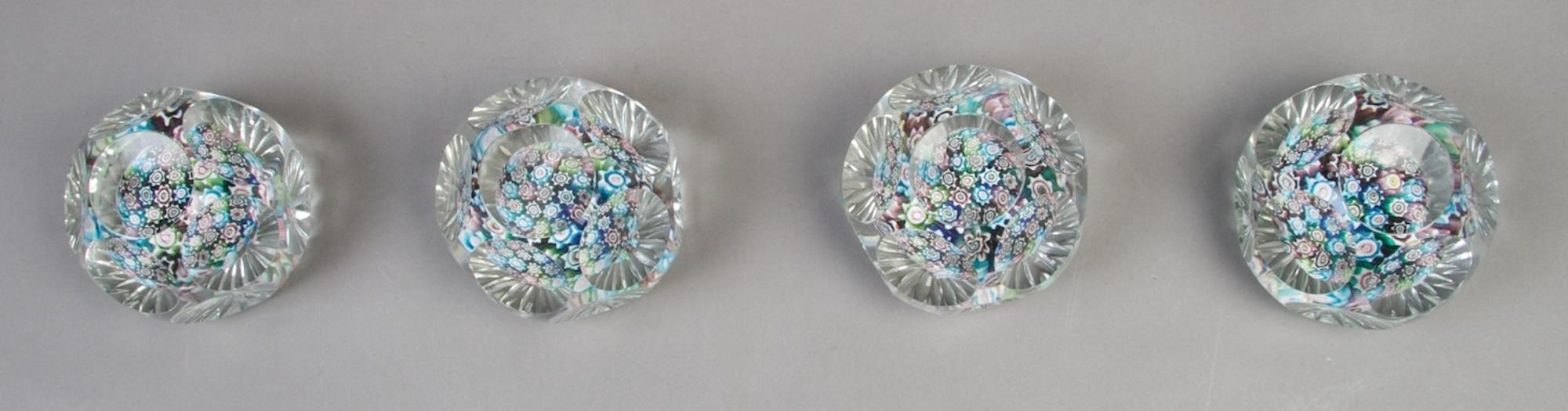 A Collection of Four Faceted Caned Paperweights, Diameter 3 inches.