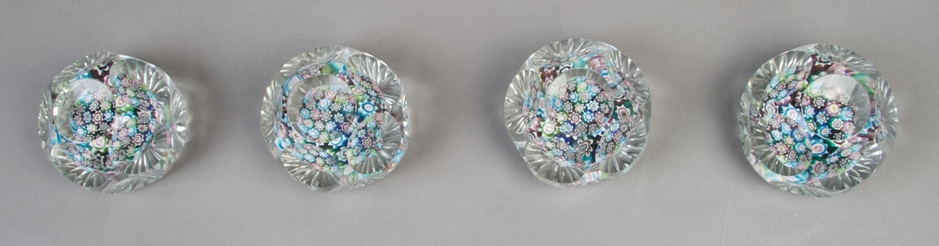 A Collection of Four Faceted Caned Paperweights, Diameter 3 inches.