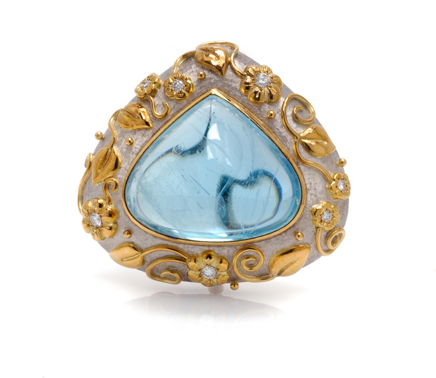 An 18 Karat Two Tone Gold, Aquamarine and Diamond Brooch, Elizabeth Gage, 44.30 dwts.
