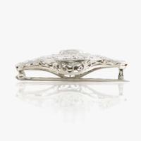 A sapphire, diamond, platinum, and white metal brooch