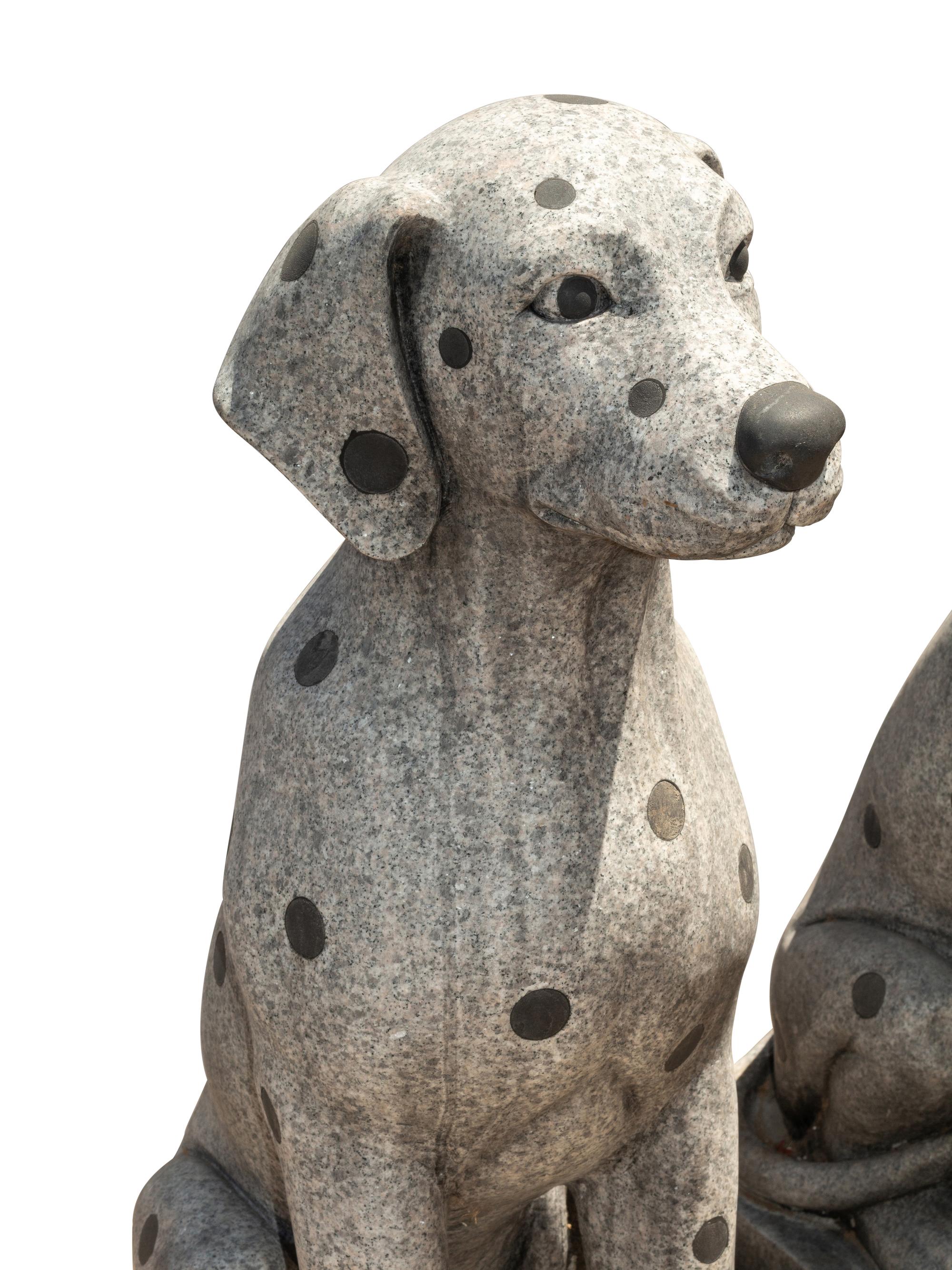 A Pair of Carved Granite and Black Marble Inlaid Seated Dogs