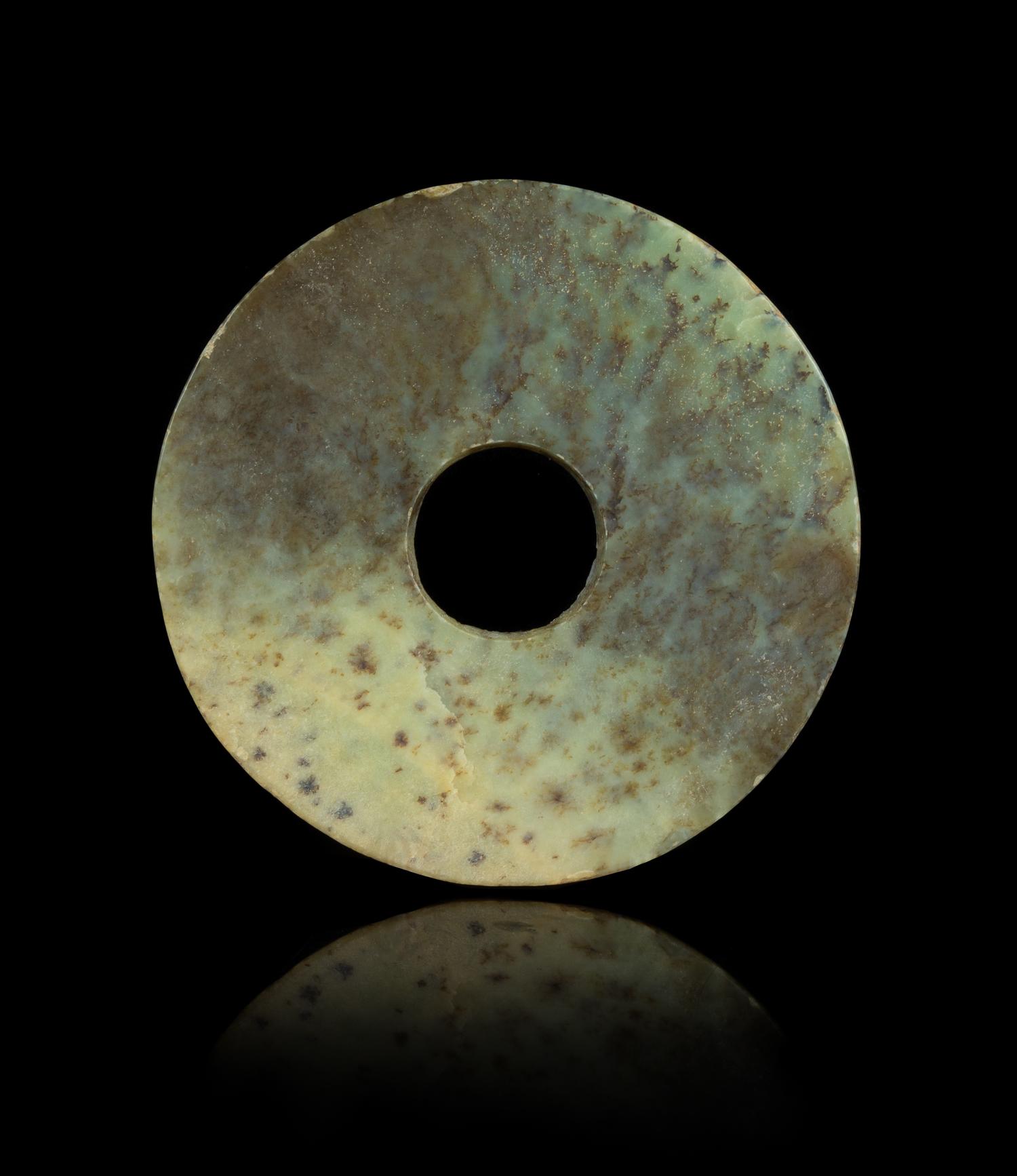 A Chinese Archaic Mottled Green Jade Bi Disk