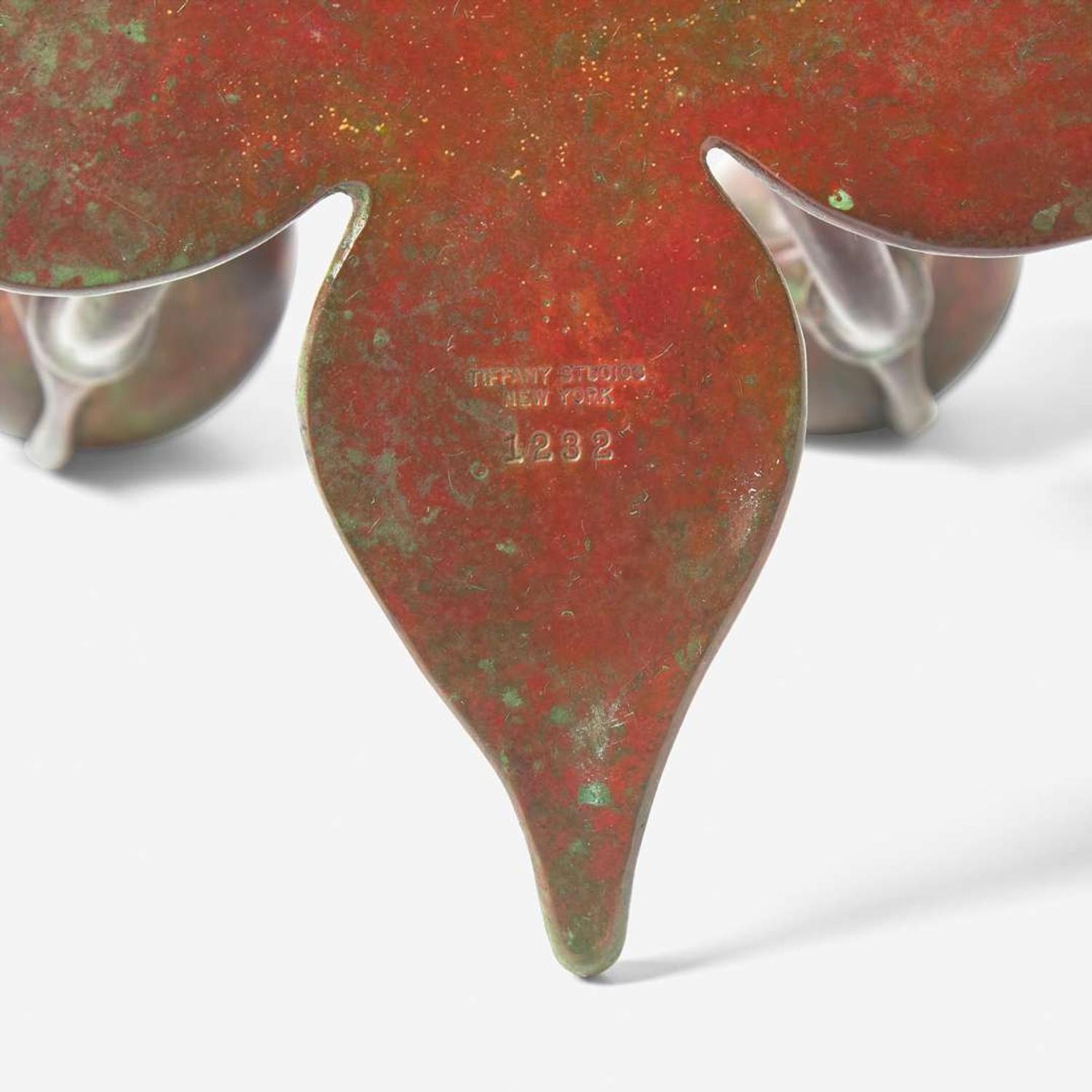 Tiffany Studios (American, active 1878-1932) A Bronze "Fleur de Lis" Two-Light Candelabra with Snuffer, USA, circa 1910