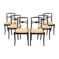 A Suite of Six Regency Ebonized and Caned Dining Chairs