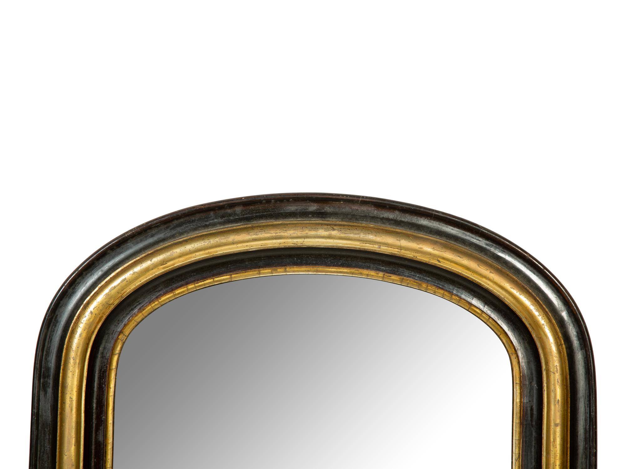 A Victorian Ebonized and Parcel Gilt Mirror